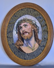 Cristo bordado con marco oval. Mide: 36 x 27 cm.