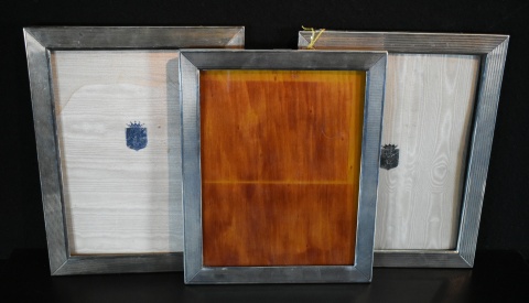 Tres Portarretratos distintos de metal sellado, dos de Settepassi. Soportes con desperfetos. Altura: 29; 28,5 y 27 cm.