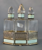 Perfumero triple de plata y esmalte turquesa, recipientes y tapones de cristal, estos últimos con cascaduras. Alto: 11