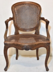 SILLON LUIS XV, de nogal tallado, asiento y respldo esterillado. Cachet de la casa Naón. S XVIII