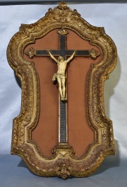 Crucifijo de marfil tallado. Cruz de madera. Marcos dorado con tiros polilla. Alto Cristo 30 cm. Alto marco: 96 cm.
