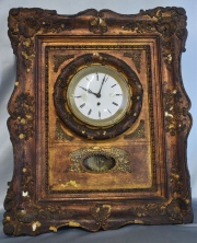Reloj de pared, marco dorado. Maquinaria de bronce dorado con péndulo. Deterioros. Mide: 55 x 45 cm. -253