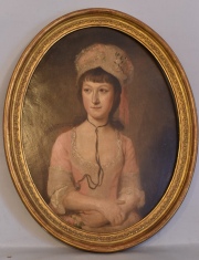 Retrato de Mujer con flor, óleo oval. Mínimos tiros de polilla. Mide: 45 x 34 cm.