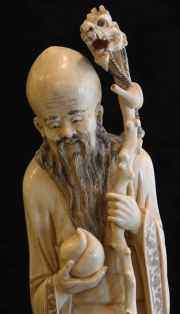 Figura oriental de marfil tallado. Base de madera. Alto total: 36 cm.